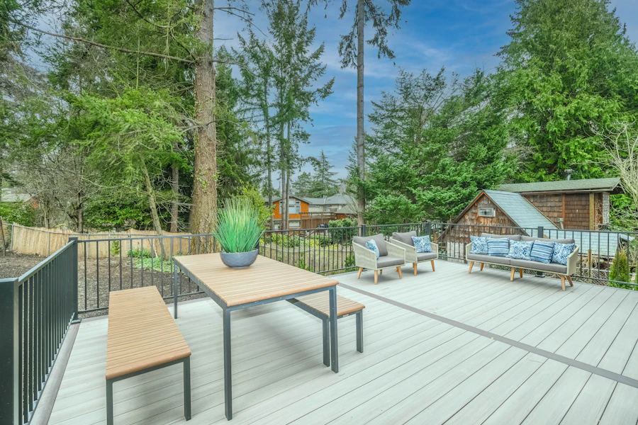 Light-gray composite deck boards with dark metal railing