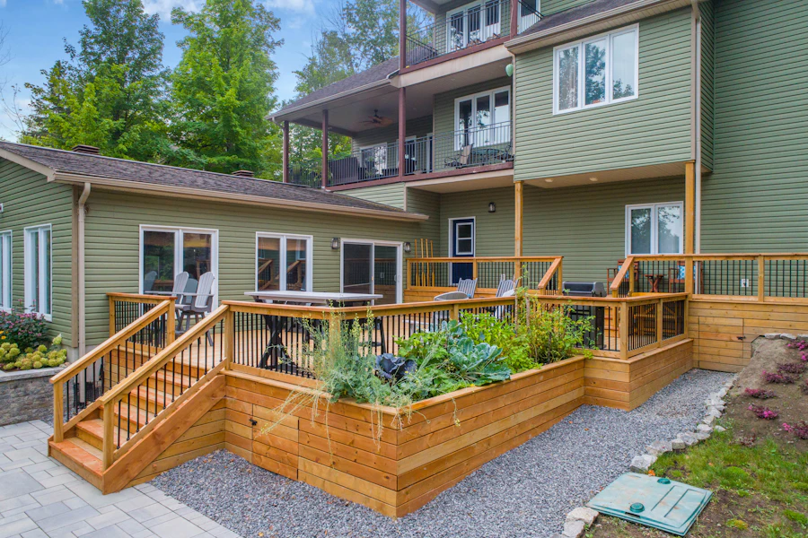 Cedar deck with railings and built-in planter boxes beside a house